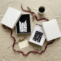 Подаръчни кутии noDRAMA с тениски Bad on Purpose и Good on Paper, панделка и кафе